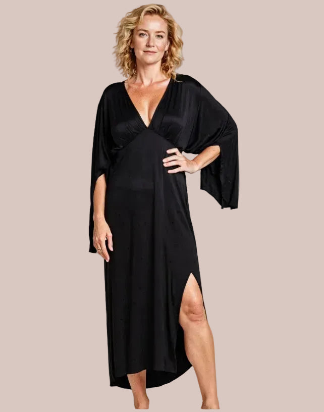 Woman wearing a black dress with a draped design on a beige background